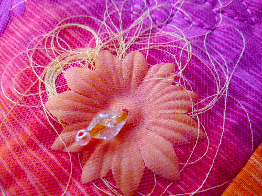 silk flower on fabric with beads