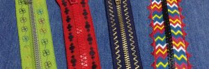 Four decorated zippers